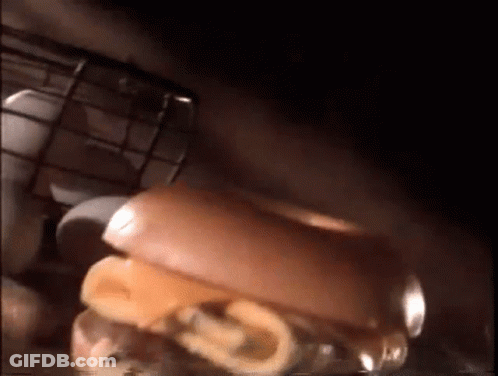 Three Donuts On Cutting Board With Knife GIF