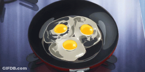 Three Eggs Are Cooking In A Pan On A Stove GIF