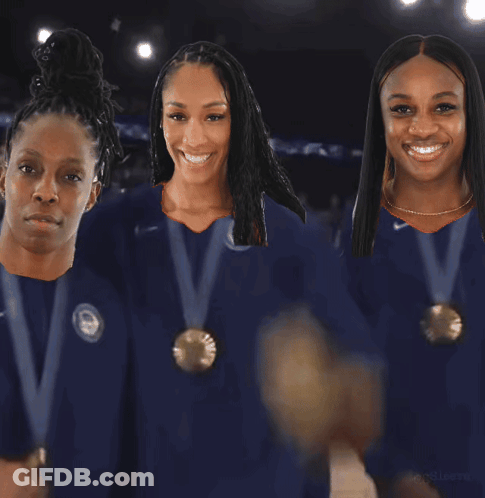 Three Female Athletes Wearing Medals Are Standing Next To Each Other GIF