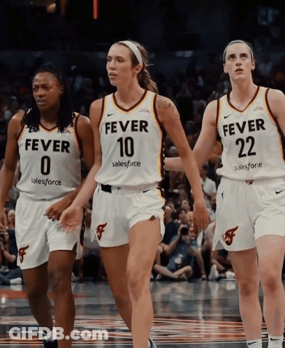 Three Female Basketball Players Wearing Fever Jerseys Walk On The Court GIF