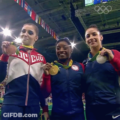 Three Female Gymnasts Are Posing For A Picture With One Wearing A Jacket That Says ' Dc Chg ' On It GIF