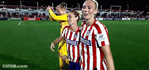 Three Female Soccer Players Wearing Red And White Striped Jerseys With Herbalife Nutrition Written On The Front GIF