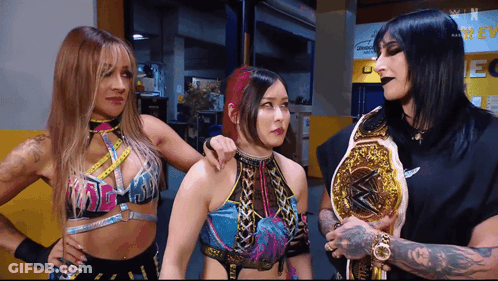 Three Female Wrestlers, One With Championship Belt GIF