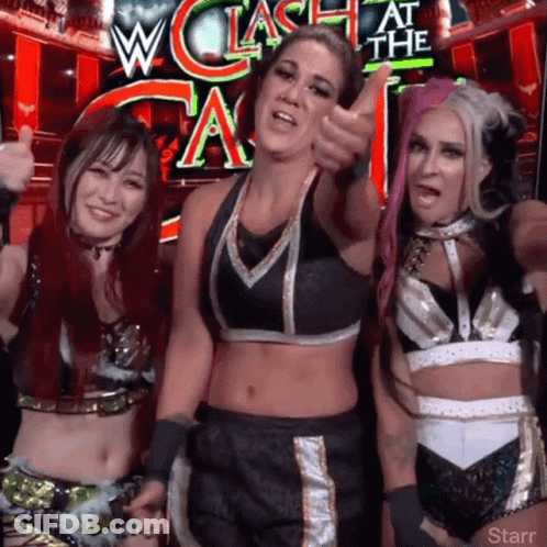 Three Female Wrestlers Posing In Front Of W Clash At The A Sign GIF