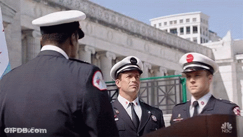 Three Firefighters Are Standing Next To Each Other In Front Of A Podium . GIF
