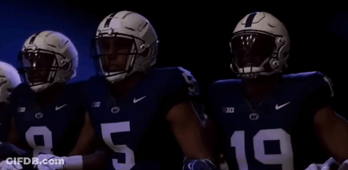 Three Football Players Standing In Dark Room GIF
