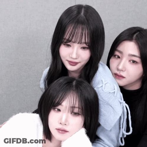 Three Girls Are Posing For A Picture And One Of Them Is Wearing A White Sweater GIF