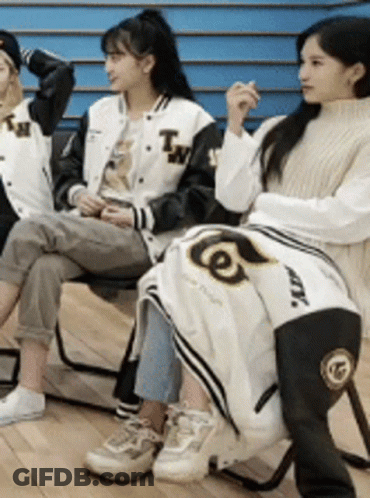 Three Girls Are Sitting On Chairs With A Blanket On Their Lap . GIF