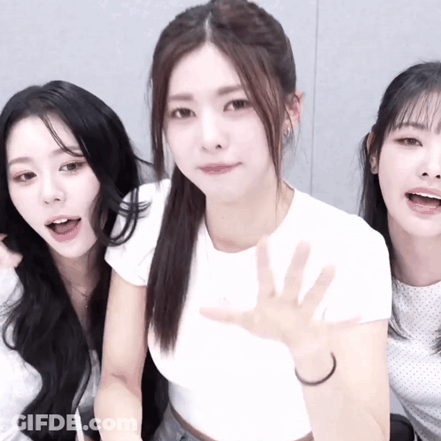 Three Girls Posing, One Waving GIF