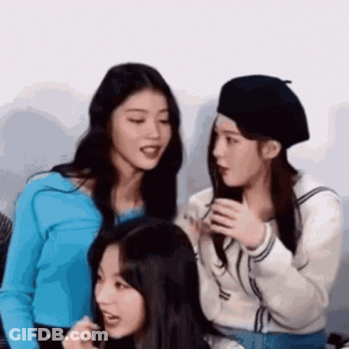 Three Girls Sitting Next To Each Other Talking One In Beret GIF