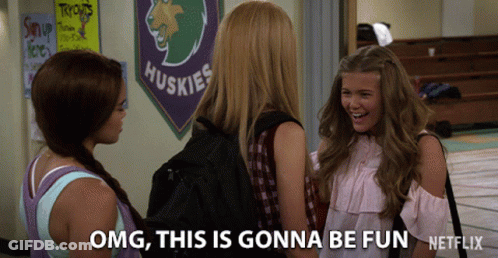 Three Girls Talking In Front Of Huskies Banner GIF