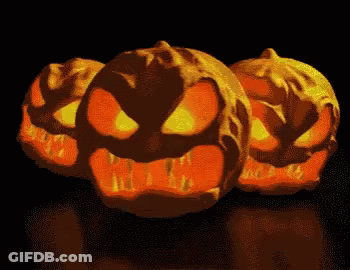 Three Glowing Pumpkins Lined Up GIF
