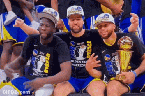 Three Golden State Warriors Players Are Posing For A Picture With Their Trophies . GIF