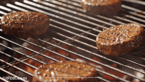 Three Hamburgers Cooking On Grill GIF