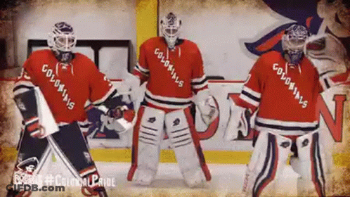 Three Hockey Players Wearing Colonials Jerseys Are Dancing On The Ice GIF