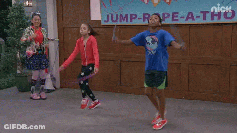 Three Kids Jump Rope In Front Of A Sign That Says Jump Rope-A-Thon GIF