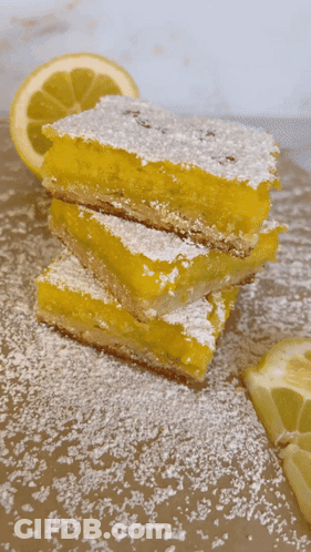 Three Lemon Bars Stacked With Powdered Sugar GIF