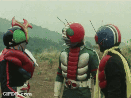 Three Masked Riders Standing In A Field GIF