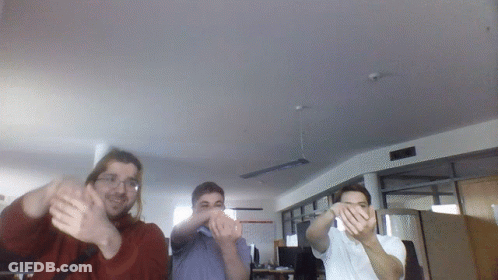 Three Men Are Clapping In A Room With A Ceiling Fan GIF