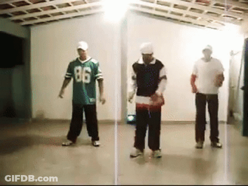 Three Men Are Dancing In A Room With One Wearing A Jersey With The Number 86 On It GIF