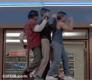 Three Men Are Dancing In Front Of A Store With A Sign That Says ' No Smoking ' On It GIF