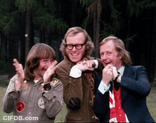Three Men Are Posing For A Picture And One Of Them Has A Badge On His Jacket That Says ' A ' On It GIF