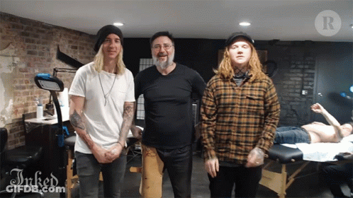 Three Men Are Posing For A Picture In A Room With The Word Inked On The Bottom GIF