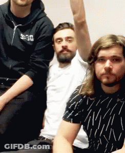 Three Men Are Posing For A Picture With One Wearing A Black Hoodie With The Word Deus On It GIF