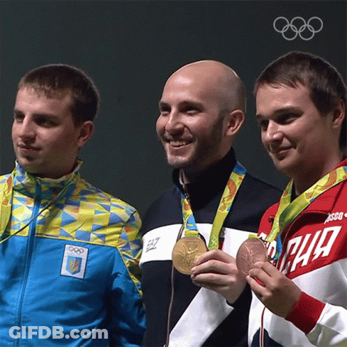 Three Men Are Posing For A Picture With One Wearing A Jacket That Says Ea7 On It GIF