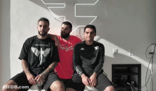Three Men Are Posing For A Picture With One Wearing A T-Shirt That Says " Fate Clan " GIF
