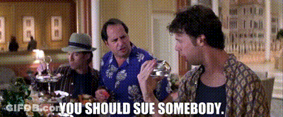 Three Men Are Sitting At A Table And One Of Them Is Holding A Glass And Says You Should Sue Somebody . GIF