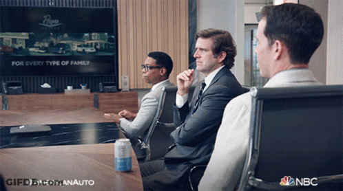 Three Men Are Sitting At A Table With A Can Of Soda On It And A Nbc Logo In The Corner GIF