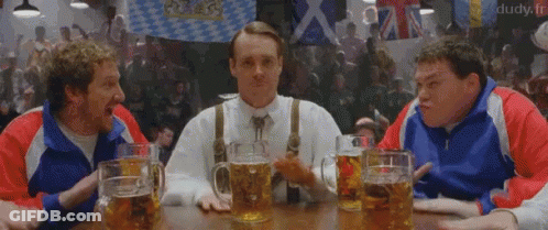 Three Men Are Sitting At A Table With Mugs Of Beer In Front Of Them . GIF