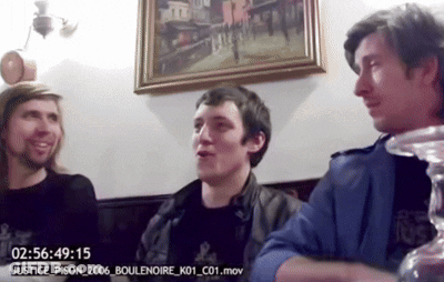 Three Men Are Sitting In Front Of A Clock That Says 02:56:49 15 GIF