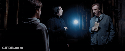 Three Men Are Standing In A Dark Room And One Of Them Is Holding A Letter GIF