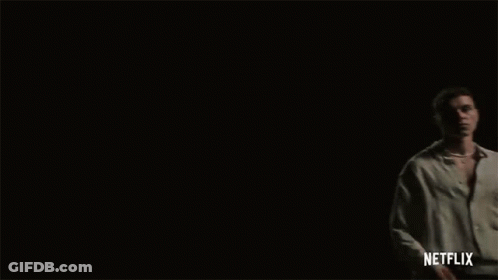 Three Men Are Standing In A Dark Room With Netflix Written On The Bottom Right GIF