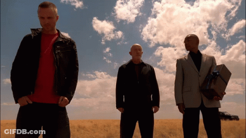 Three Men Are Standing In A Field And One Is Holding A Gift Box GIF