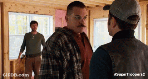 Three Men Are Standing In A Room Talking To Each Other . GIF