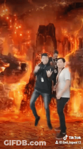 Three Men Are Standing In Front Of A Fire Background . GIF