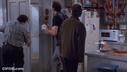 Three Men Are Standing In Front Of A Refrigerator That Has A Sticker On It That Says ' A ' On It GIF