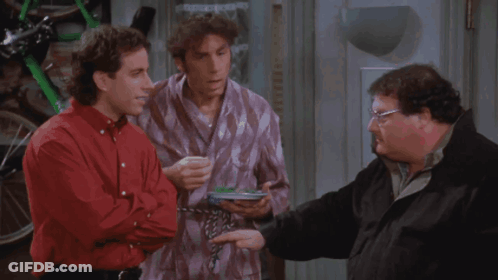 Three Men Are Standing Next To Each Other And One Has A Plate Of Food GIF