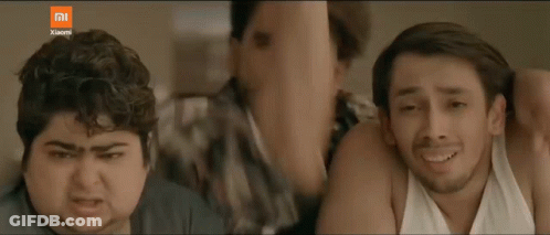 Three Men Are Standing Next To Each Other And One Is Holding A Cell Phone With The Xiaomi Logo On The Bottom GIF
