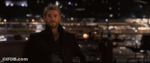 Three Men Are Standing Next To Each Other And One Of Them Is Holding A Bottle GIF