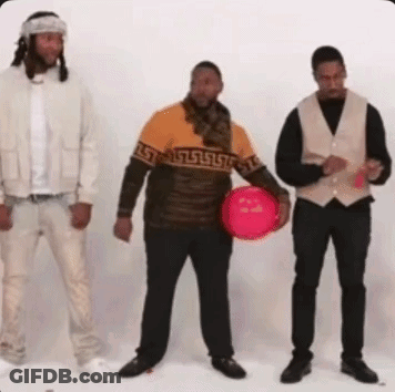 Three Men Are Standing Next To Each Other And One Of Them Is Holding A Red Ball . GIF