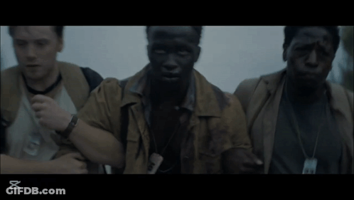 Three Men Are Standing Next To Each Other In A Dark Room With The Letters Xt On The Bottom GIF