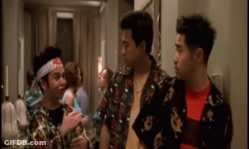 Three Men Are Standing Next To Each Other In A Room And One Of Them Has A Bandana On His Head . GIF