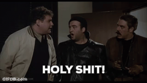 Three Men Are Standing Next To Each Other In A Room And One Of Them Is Holding A Gun And Saying Holy Shit . GIF