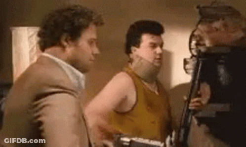 Three Men Are Standing Next To Each Other In A Room And Talking To Each Other . GIF