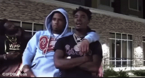 Three Men Are Standing Next To Each Other In Front Of A Building . GIF