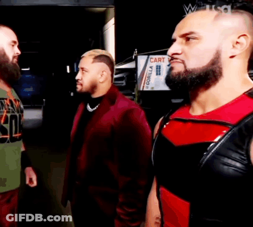 Three Men Are Standing Next To Each Other In Front Of A Gorilla Sign GIF